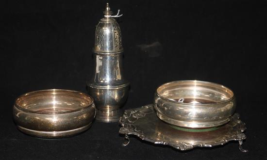 A small circular silver waiter with shaped anthemion-cast rim, a silver sugar caster and a pair of small silver bottle coasters
